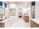 Well-lit bathroom with modern fixtures, a walk-in shower, soaker tub, and storage at 3087 S Dexter Way, Denver, CO 80222