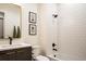 Modern bathroom with a tub, shower, sleek vanity, and decorative artwork at 3087 S Dexter Way, Denver, CO 80222