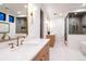Modern bathroom features a double vanity, glass-enclosed shower, and soaking tub at 3087 S Dexter Way, Denver, CO 80222
