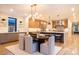 Bright, open-concept dining area features modern light fixture and seamless transition to the gourmet kitchen at 3087 S Dexter Way, Denver, CO 80222