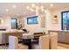Elegant dining area with a modern chandelier, seamlessly connected to the living room, perfect for entertaining at 3087 S Dexter Way, Denver, CO 80222
