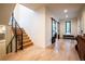 Inviting entryway with hardwood floors, modern staircase, sliding door and lots of natural light at 3087 S Dexter Way, Denver, CO 80222