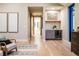 Hallway features a drink station, hardwood floors, and a hallway leading to bedrooms at 3087 S Dexter Way, Denver, CO 80222