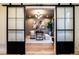 Home office with large sliding doors, hardwood floors, stylish decor, and ample natural light at 3087 S Dexter Way, Denver, CO 80222