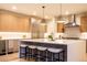 Modern kitchen featuring a large island, stainless steel appliances, and sleek countertops with bar stool seating at 3087 S Dexter Way, Denver, CO 80222