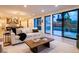 Bright living room flows into a modern kitchen with large sliding glass doors to the outdoor patio at 3087 S Dexter Way, Denver, CO 80222