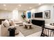 Cozy living area featuring a sectional sofa, modern artwork, and a decorative coffee table at 3087 S Dexter Way, Denver, CO 80222