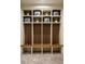 Functional mudroom with individual storage lockers, wooden slats, and cubbies with decor at 3087 S Dexter Way, Denver, CO 80222