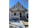 Charming craftsman home with a welcoming front porch and snowy landscaping at 351 S Corona St, Denver, CO 80209