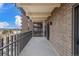 Outdoor balcony space with brick siding, metal railings and views of the neighboring city at 460 S Marion Pkwy # 1106, Denver, CO 80209
