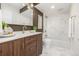 Modern bathroom featuring stylish fixtures, a bathtub, and a marble-tiled shower at 460 S Marion Pkwy # 1106, Denver, CO 80209