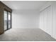 Bright bedroom featuring soft carpet, a private balcony, and spacious closet at 460 S Marion Pkwy # 1106, Denver, CO 80209