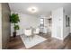 Bright dining room features a modern light fixture, wood floors, and white chairs at 460 S Marion Pkwy # 1106, Denver, CO 80209