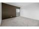A large room is carpeted and has a sliding glass door that opens to a balcony at 460 S Marion Pkwy # 1106, Denver, CO 80209
