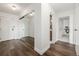 Hallway featuring wood flooring, mirrored closet doors, and neutral paint at 460 S Marion Pkwy # 1106, Denver, CO 80209