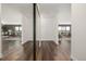 Bright hallway leads to a stylish living area, featuring sleek hardwood floors and a mirrored closet at 460 S Marion Pkwy # 1106, Denver, CO 80209
