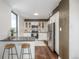 Bright kitchen with a stone backsplash, white cabinets, and stainless-steel appliances at 460 S Marion Pkwy # 1106, Denver, CO 80209
