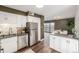 Bright kitchen features white cabinets, stainless steel appliances, and an adjacent dining area at 460 S Marion Pkwy # 1106, Denver, CO 80209