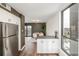 Modern kitchen with stainless steel appliances and lots of natural light from the large window at 460 S Marion Pkwy # 1106, Denver, CO 80209