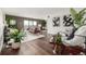 Modern living room with hardwood floors, stylish decor, ample natural light, and a sliding glass door at 460 S Marion Pkwy # 1106, Denver, CO 80209