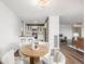 Open-concept living space featuring dining table set near the kitchen and living room at 460 S Marion Pkwy # 1106, Denver, CO 80209