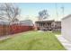 Large, green backyard featuring a pergola-covered patio, a shed, and a privacy fence at 3640 York St, Denver, CO 80205