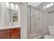 Bright bathroom featuring a vanity with granite countertop and a shower with glass doors at 3640 York St, Denver, CO 80205