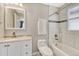 Bathroom featuring white vanity, toilet, and a shower-tub with tile surround at 3640 York St, Denver, CO 80205