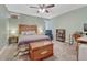 Bedroom with light green walls and a wooden headboard on a bed with colorful blankets at 3640 York St, Denver, CO 80205