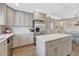 Modern kitchen with gray cabinets, stainless steel appliances, and a marble-topped island at 3640 York St, Denver, CO 80205