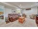 Comfortable living room with brown leather sofa, accent chairs, and soft carpeting at 3640 York St, Denver, CO 80205