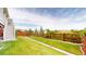 Well-maintained backyard with a lush lawn and wooden fence, perfect for outdoor activities at 5932 Eldora St, Golden, CO 80403