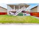 A spacious backyard with a covered deck, stairs, and a relaxing hot tub for outdoor enjoyment at 5932 Eldora St, Golden, CO 80403