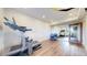Bright basement workout area featuring wood-look floors, workout equipment, and mirrored wall for exercise at 5932 Eldora St, Golden, CO 80403