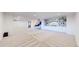 Large basement with plush carpet, built-in shelves, and modern entertainment setup at 5932 Eldora St, Golden, CO 80403