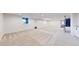 Spacious finished basement with neutral carpet, recessed lighting, and egress windows for natural light at 5932 Eldora St, Golden, CO 80403