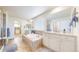 Luxurious bathroom with a soaking tub, double vanity, and tiled floors, offering a spa-like experience at 5932 Eldora St, Golden, CO 80403