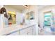 Bright bathroom featuring a white vanity with granite countertop and view into the bedroom at 5932 Eldora St, Golden, CO 80403