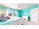 Charming bedroom with bright turquoise walls, a ceiling fan and lots of natural light at 5932 Eldora St, Golden, CO 80403
