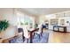 Elegant dining area with sliding doors, a wooden table set for six, and hardwood floors, perfect for dinner parties at 5932 Eldora St, Golden, CO 80403