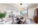 Spacious dining room features a tray ceiling, elegant chandelier, and large windows, creating a warm and inviting atmosphere at 5932 Eldora St, Golden, CO 80403