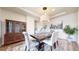 Charming dining area with a wooden table set for four, a decorative rug, and traditional china cabinet, creating a warm ambiance at 5932 Eldora St, Golden, CO 80403