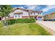 Charming two-story home with lush green lawn, mature landscaping, and well-maintained exterior at 5932 Eldora St, Golden, CO 80403