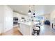 Modern kitchen featuring a large center island, stainless steel appliances, and a seamless flow to the dining area at 5932 Eldora St, Golden, CO 80403