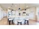 Well-equipped kitchen with a large center island, pendant lighting, stainless steel appliances, and ample counter space at 5932 Eldora St, Golden, CO 80403