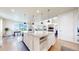 Spacious kitchen featuring a center island with bar stools, stainless appliances, and an open design for entertaining at 5932 Eldora St, Golden, CO 80403
