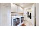 Well-organized laundry room with abundant cabinets and a new, front-load washer and dryer at 5932 Eldora St, Golden, CO 80403