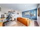 Second living room showcases a blue accent wall, leather couch, desk, and guitars at 5932 Eldora St, Golden, CO 80403