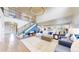 Spacious living room features a staircase, modern lighting, and an open layout for easy entertaining at 5932 Eldora St, Golden, CO 80403