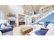Bright living room boasts soaring ceilings, a cozy fireplace, and a stylish staircase leading to the upper level at 5932 Eldora St, Golden, CO 80403